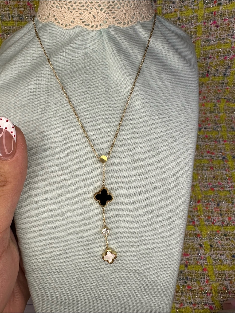 A great Gold Lariat Necklace with Black and Pink Clover Charms